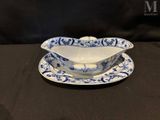 an antique blue and white porcelain gravy dish and saucer