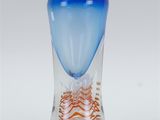 a glass vase with a blue and orange design on it