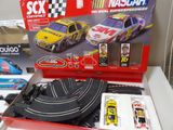 a box with a toy car and other toy cars in it