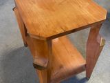 a wooden table with a shelf on it in a room