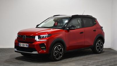a red toyota rav parked in a room with a checkered floor