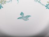 a white plate with a blue bird on it