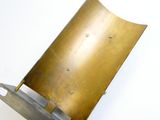 a metal object that is sitting on a white surface