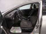 the interior of a car with the door open and the driver ' s seat down