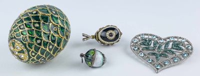 several pieces of jewelry are displayed on a white surface