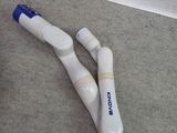two electric toothbrushes laying on the floor next to each other