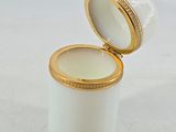 an image of a white and gold box with a lid