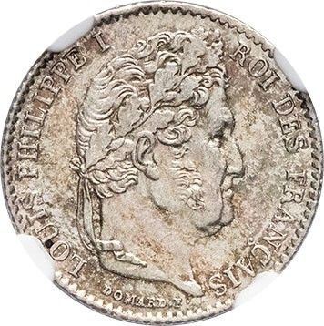 a silver coin with a woman ' s head on it