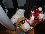 a pile of christmas decorations on the floor next to a door