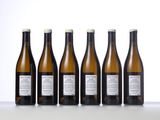 six bottles of wine are lined up on a table
