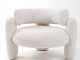 a white chair that is sitting on a white surface