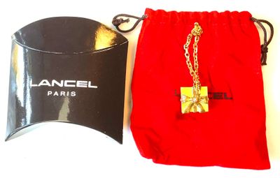 a red bag with a gold chain and a red bag with a gold chain