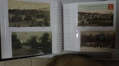 an open book with pictures of a town in it