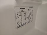 a sign on the side of a white toilet