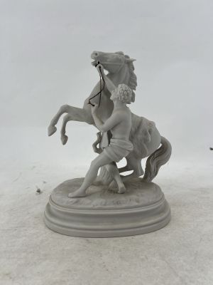 a statue of a man riding a horse on a pedestal