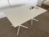 a white table with two chairs and a laptop on it