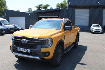 a yellow pickup truck parked in a parking lot