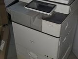 a stack of papers sitting on top of a printer