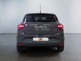the back end of a grey car in a white room