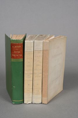 three books are stacked on top of each other on a gray surface