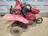 an image of a pink lawn mower in a garage