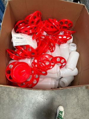 a cardboard box filled with plastic bottles and a pair of shoes