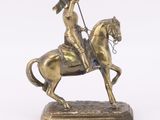 statue of a man riding a horse with a flag on its back