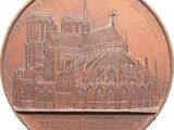 a bronze medal with a picture of a cathedral on it