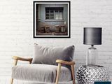 a picture of a chair in front of a white brick wall