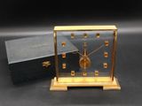 a small clock that is sitting on top of a box