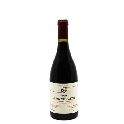 the bottle of red wine is sitting on a white surface