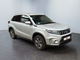the white suzuki vitax is parked in a room with a black floor