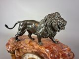 a statue of a lion on top of a clock