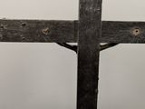 a close up of a wooden cross with a ring on it