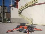 a picture of a man on a cherry picker in front of a building