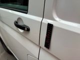 a close up of a car door handle with a sticker on it