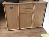 a tv that is sitting on top of a wooden cabinet