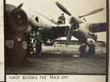 a black and white photo of a man standing in front of a plane