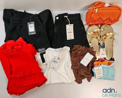 a pile of clothes and a pair of sandals on a table