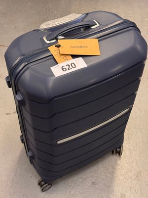 a suitcase with a tag on it sitting on the floor