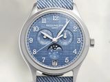 a close up of a wrist watch with a blue dial