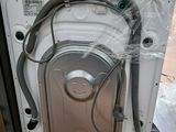 an image of a washing machine that is in the process of being installed