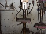 a picture of a drill and drill press in a garage
