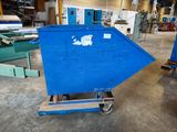 a blue dumpster sitting in the middle of a warehouse