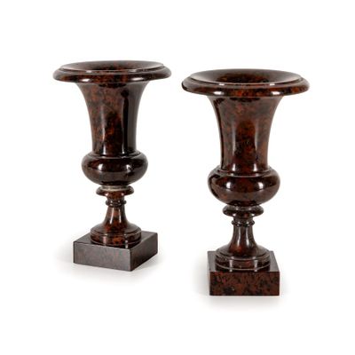 two brown vases sitting on top of each other on a white surface