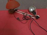 a lamp that is sitting on the floor next to a wall