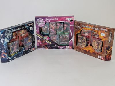 trois types de jouets différents se trouvent dans une boîte posée sur une surface blanche