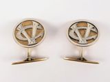 pair of silver and gold cufflinks with the letter y on them