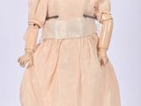 an image of a doll of a woman in a dress and hat