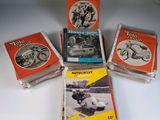 five motorcyclist books are stacked on a white surface